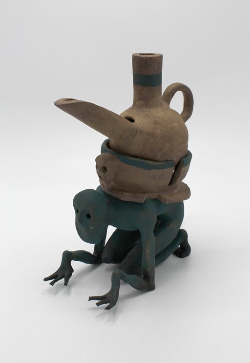 crouched green figure with vessel on back