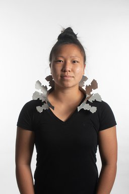 Girl wearing metal necklace mimicking high collar
