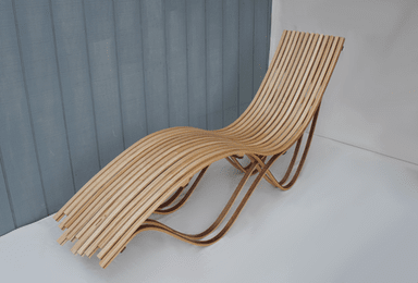 Lounge chair made of wooden slabs with flowing rhy