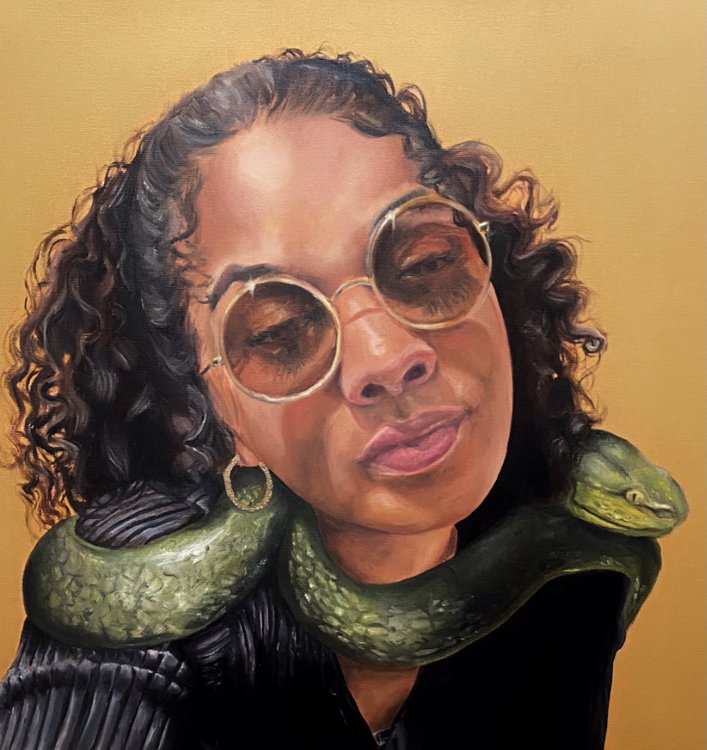 Portrait of woman facing camera with green serpent