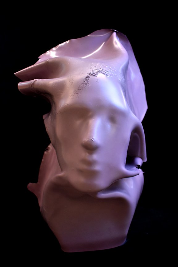 Pink, dried latex paint over facial mold