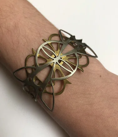 metal cuff of overlapping brass and silver designs