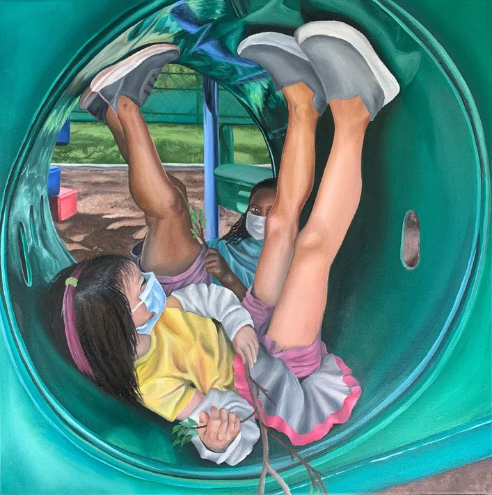 Two children inside green playground tube; feet up