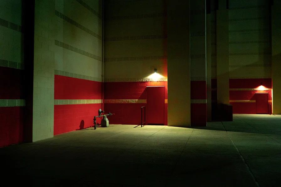 Exterior of building in green and red with two lig