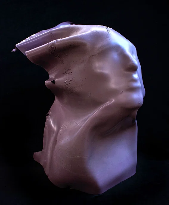Pink, dried latex paint over facial mold